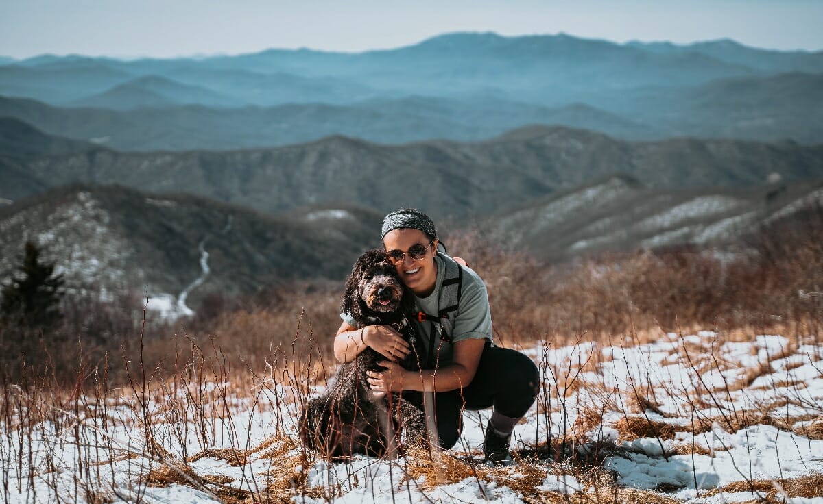 Dog owner Taylor Schmidt stands with her labradoodle, Wally, at a summit in Tennessee