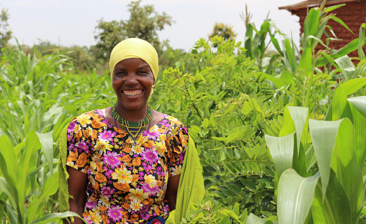 A forest garden farmer stands in her garden