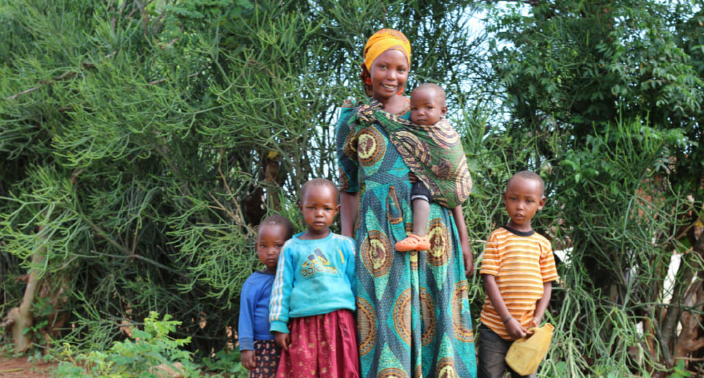 A forest garden farmer with her children