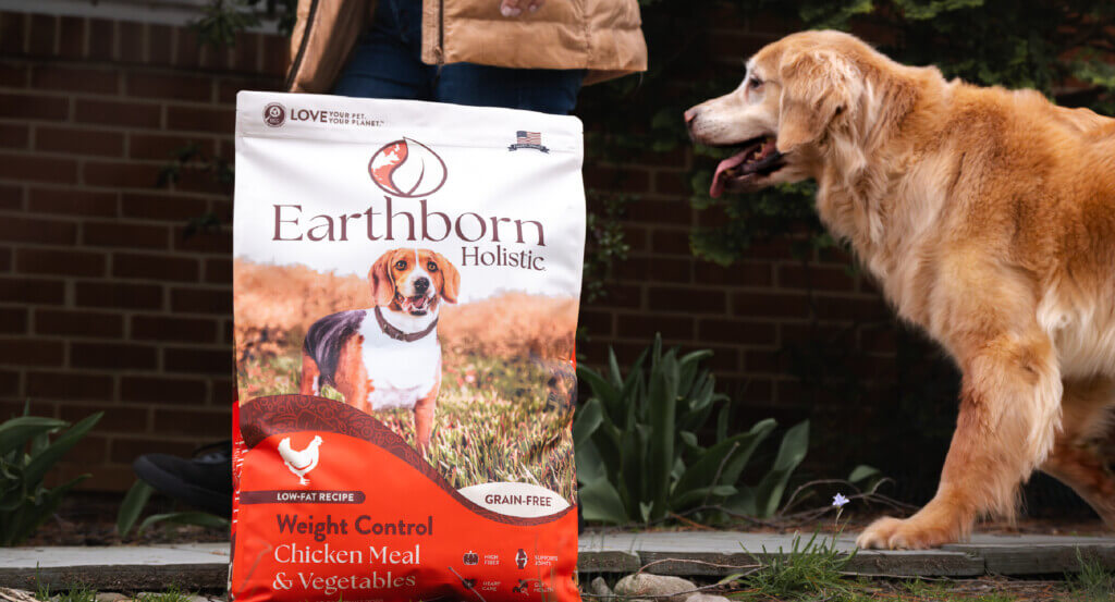 Woman and dog stand behind bag of Weight Control dog food