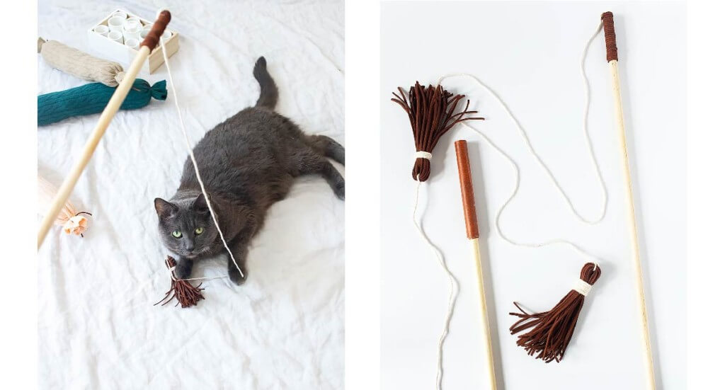 A cat plays with a DIY wand toy