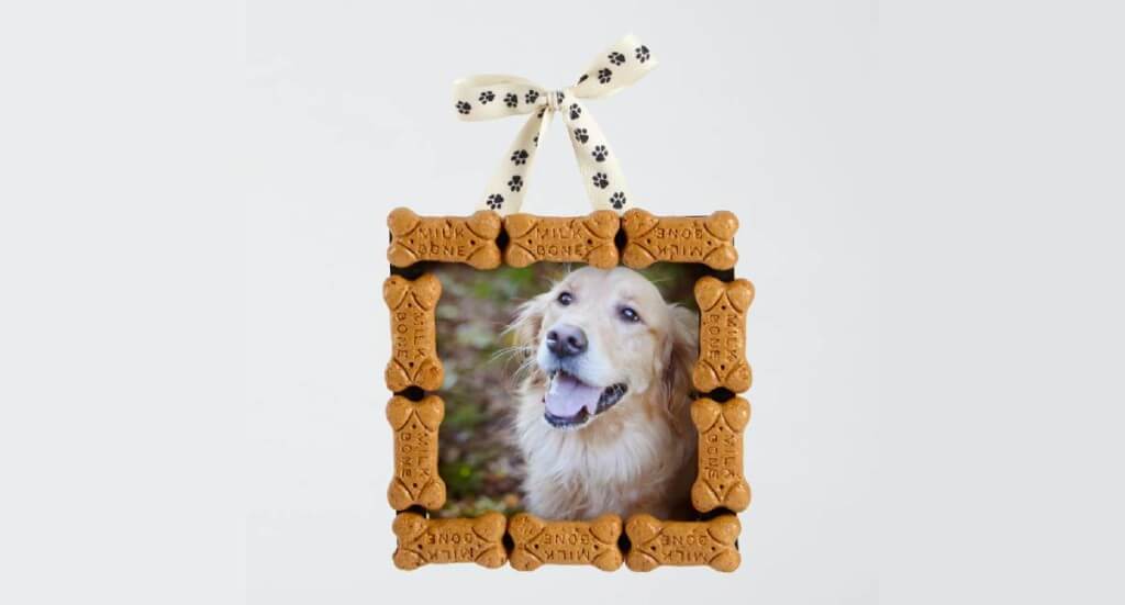 An ornament with a photo of a dog surrounded by dog treats