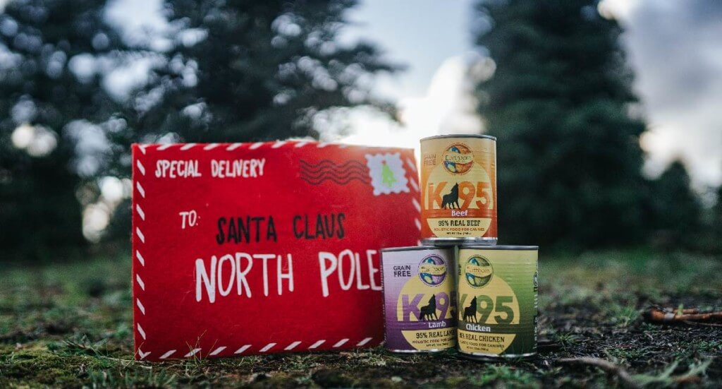 A stack of K95 canned dog food sits next to a letter to Santa