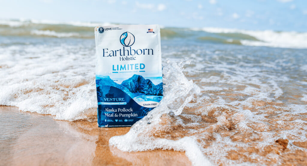 Bag of dog food sit in water as a wave hits it