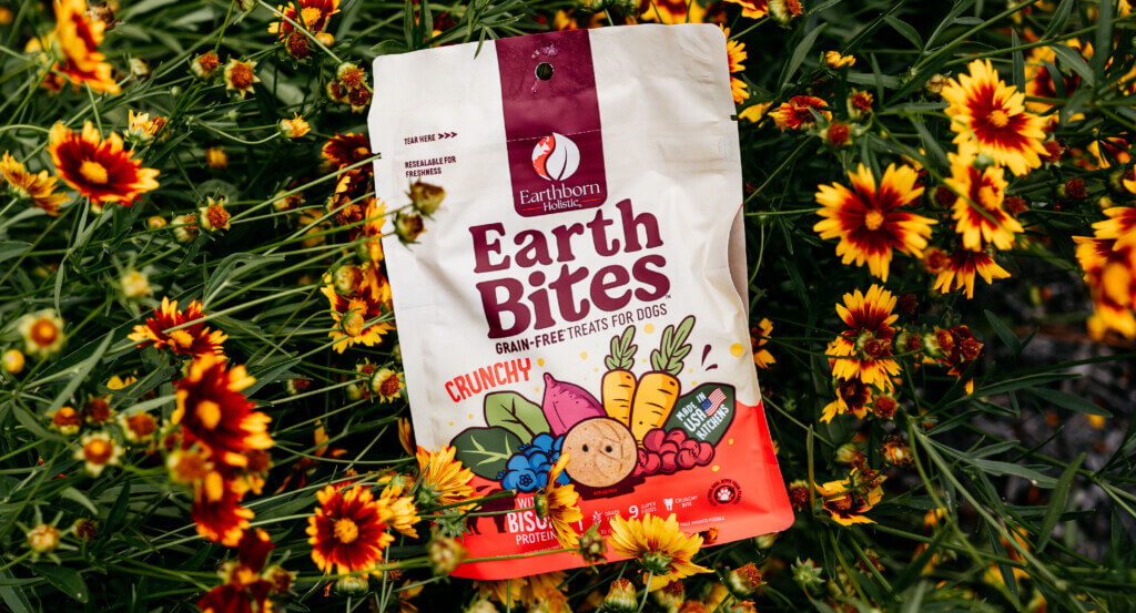 Bag of EarthBites Crunchy with flowers around them