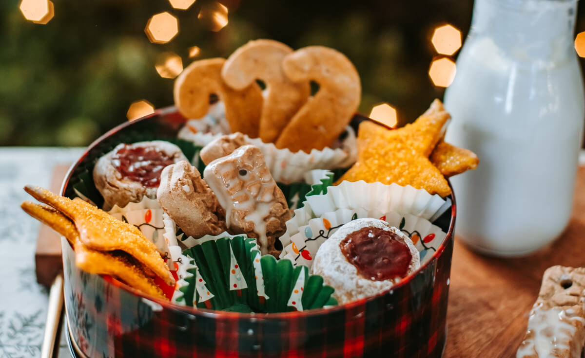 A variety of dog-friendly Christmas cookies in a cookie tin