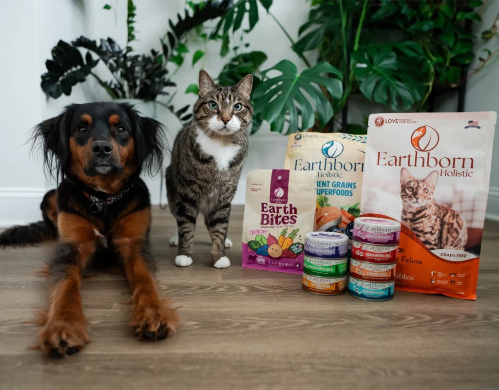 dog and cat next to a grouping of Earthborn Holistic dog and cat products